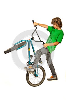 Teen boy trying stunt on bike