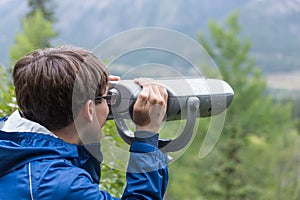 Teen boy using binoculars