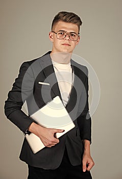 teen boy wear formal suit and glasses use laptop, business