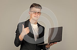 teen boy wear formal suit and glasses use laptop, education