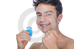 Teen boy wearing braces on white background
