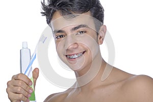 Teen boy wearing braces on white background