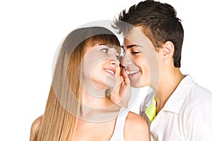 Teen boy whispering in his girlfriend's ear