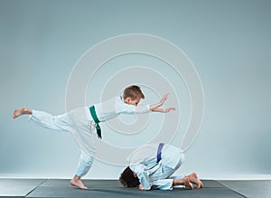 The two boys fighting at Aikido training in martial arts school. Healthy lifestyle and sports concept