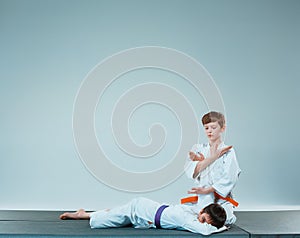 The two boys fighting at Aikido training in martial arts school. Healthy lifestyle and sports concept photo