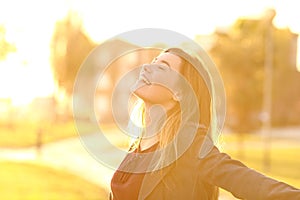 Teen breathing at sunset in a park