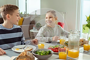 Teen brother and sister eating healthy breakfast at home