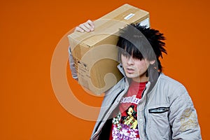 Teen carrying cardboard box