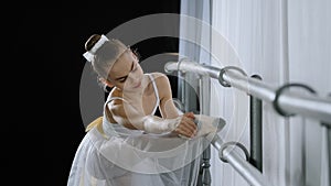 Teen caucasian ballerina girl teenager dancer child student in dance hall doing choreographic exercise at dance school