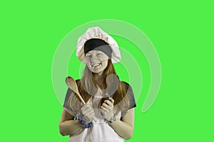 Teen in chef apron and hat green screen