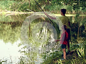 Teen child catches a fishing rod on the pond