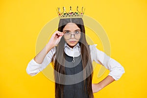 Teen child in queen crown isolated on yellow background. Princess girl in tiara. Teenage girl wear diadem. Serious