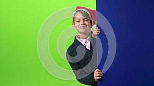 Teen in christmas hat appears from the side boards on a green screen. Slow motion