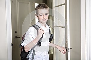 Teen coming home passing through the door.