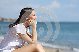 Teen contemplating and relaxing on the beach on summer