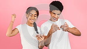 Teen couple playing video games on smartphones