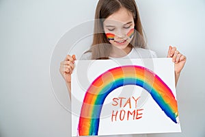 Teen drew rainbow and poster stay home. photo