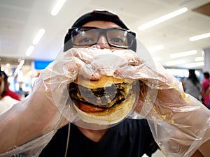 Teen eating a big hamburger