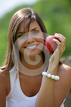 Teen eating red apple