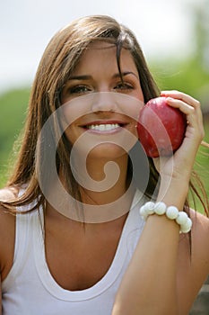 Teen eating red apple