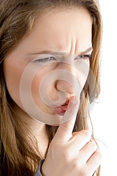 Teen female face showing keep shushing sign photo