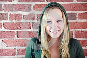 Teen in front of brick wall