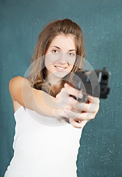 Teen girl aiming a gun