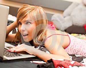 Teen girl in bed with laptop