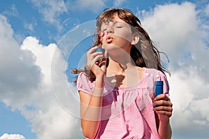Teen girl blow bubbles