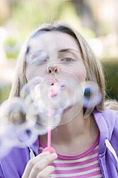 Teen Girl Blowing Bubbles