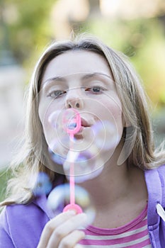 Teen Girl Blowing Bubbles