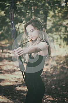 Teen girl with bow and arrow