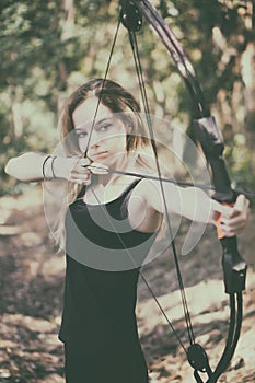 Teen girl with bow and arrow