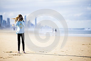 Teen girl with camera on beach