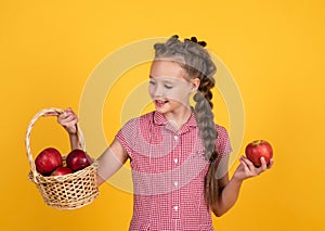 teen girl carry apples in basket. autumn harvest. spring season fruits. full of vitamins. organic food only. natural and