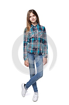 Teen girl in checkered shirt standing casually