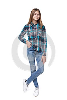 Teen girl in checkered shirt standing casually