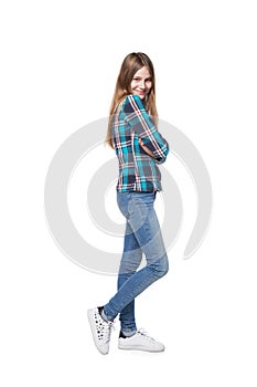 Teen girl in checkered shirt standing casually