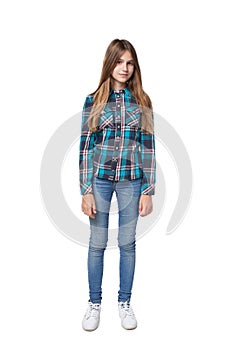 Teen girl in checkered shirt standing casually