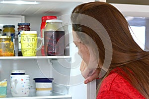 Teen girl checking out the fridge