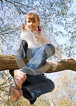 Teen girl climbing on the tree