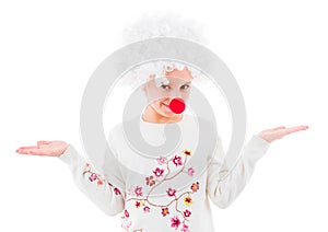 Teen girl in clown wig and red nose isolated