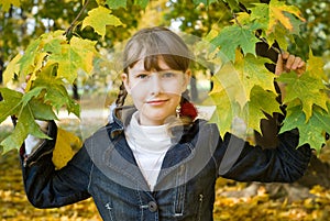 Teen girl with colored maple leaves