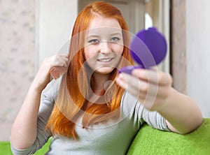 Teen girl combing hair