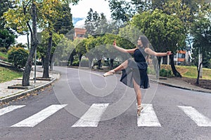 Teen girl dancer taking a selfie on a pedestrian crossing in the street