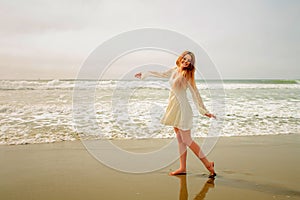 Teen girl dancing at the beach