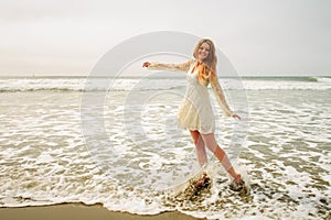 Teen girl dancing in the waves