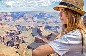 Teen girl in deep thought overlooking a canyon