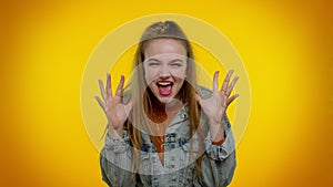 Teen girl in denim jacket demonstrating tongue out, fooling around, making silly faces, madness