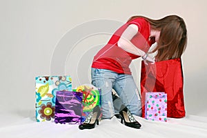 Teen girl digging in shopping bags